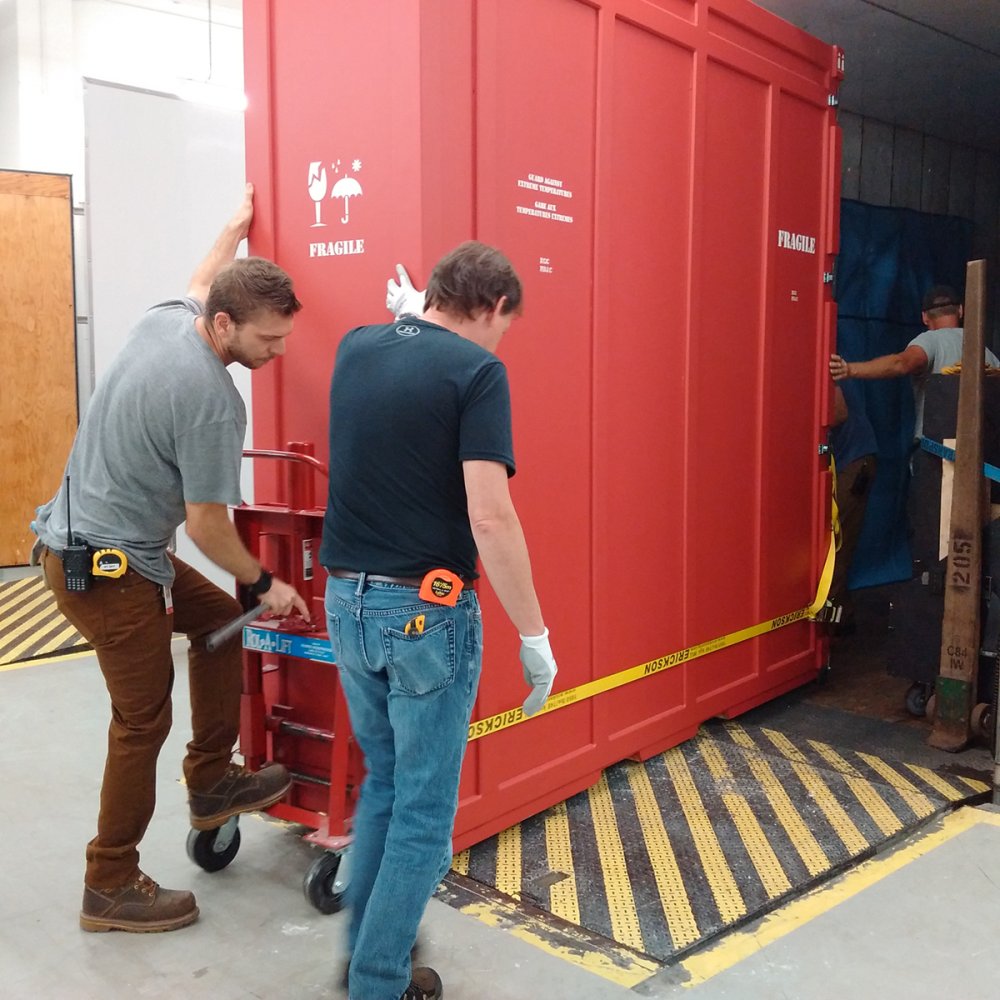 Technicians loading crates for a loan. 