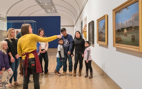 A Gallery guide discusses an artwork with a group.